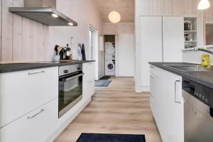 a kitchen with white cabinets and black counter tops at 16666-Farevejle-Karuphoj-4-E in Fårevejle +11 photos