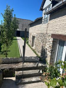 a stone house with stairs leading to a yard at NYNO DIGRABEN - House for Rent in Dol-de-Bretagne