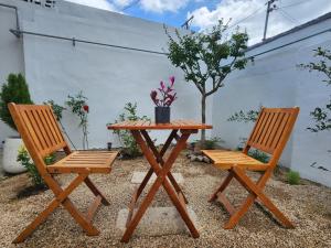 two chairs and a wooden table and a table and chairs at Hanok Stay Ohneul in Gyeongju