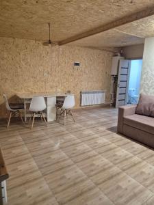 a living room with a table and chairs and a couch at Modern Apartment Near Sevan Lake in Sevan