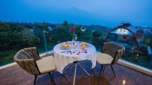 a table with a plate of food on a balcony at Alcola Boutique Villa - Astonia Unit in Batu