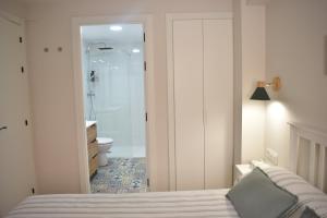 a bedroom with a bed and a bathroom with a shower at Casa El Abuelo in Bronchales +60 photos