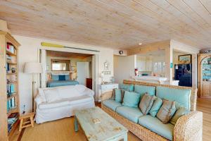 a living room with a couch and a bed at Oceanfront Delight in Cayucos