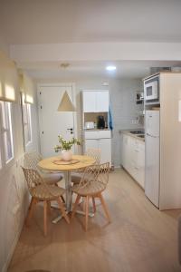 a kitchen with a table and chairs in a kitchen at Casa El Abuelo in Bronchales
