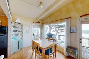 a dining room with a table and a balcony at Oceanfront Dream in Cayucos