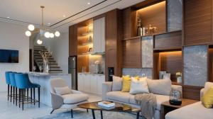 a living room with a couch and a kitchen at Alcola Boutique Villa - Bahama Unit in Malang