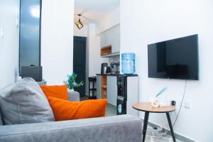 a living room with a couch and a tv at Hise Haven Stays in Kiambu +1 photo