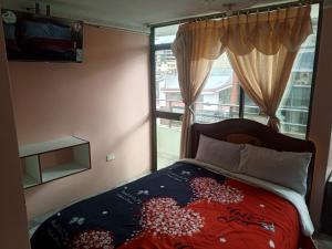 a bedroom with a bed and a window at Hotel Casa Nova in Tulcán