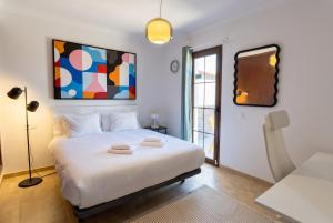 a bedroom with a white bed and a window at Villa La Genuina in Yaiza