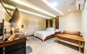 a hotel room with a bed and a desk at Bupyeong Byulha Hotel in Incheon