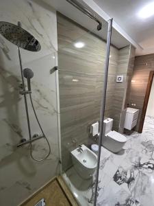a bathroom with a shower and a sink and a toilet at Appart Hôtel Stade Tanger in Tangier +7 photos