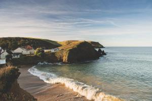 a view of a beach with houses and the ocean at Hope & Anchor in Hope Cove
