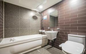 a bathroom with a white toilet and a sink at Bupyeong Byulha Hotel in Incheon +64 photos