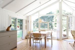 a dining room with a white table and chairs at 13376-Asnaes-Dommergardsvej-18 in Asnæs +11 photos