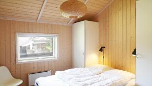 a bedroom with a bed and a window at 13376-Asnaes-Dommergardsvej-18 in Asnæs