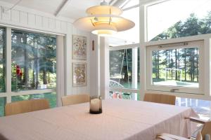 a dining room with a table with a candle on it at 13376-Asnaes-Dommergardsvej-18 in Asnæs