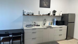 a kitchen with a sink and a refrigerator at Private Pool Retreat for Two - Golan in Qasrîne