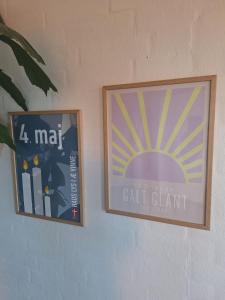 two pictures hanging on a wall in a room at Nice room with a wonderful view in Sommersted
