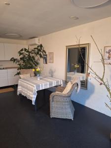 a dining room with a table and two chairs at Nice room with a wonderful view in Sommersted