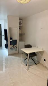 a white table and two chairs in a room at Studio cosy Ducos in Ducos
