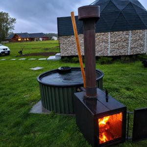 a wood stove in a yard with a fire at Domos Frutillar in Frutillar