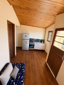 a small room with a kitchen with a refrigerator at Cabaña Acuña in Chuy