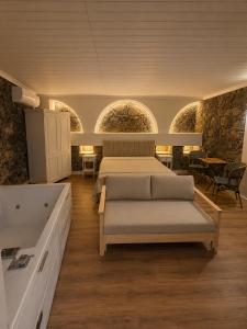 a bedroom with a bed and a bath tub at Aprosmeno House 5 in Agros