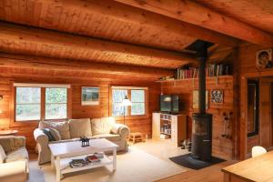 a living room with a fireplace in a log cabin at 10084-1-Rorvig-Sondervangen-12 in Rørvig
