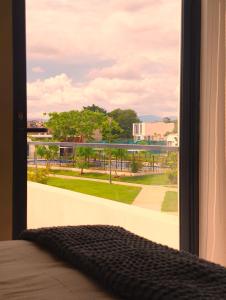 a bedroom window with a view of a park at Puerto CARMA in Las Juntas