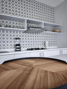a kitchen with white cabinets and a wooden floor at Puerto CARMA in Las Juntas