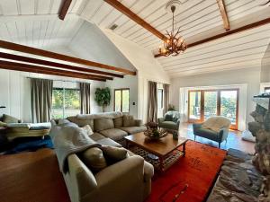 a living room with a couch and a table at EPIC VIEWS, Large Deck, BBQ, Private, Close to Julian, Great for Families or Entertaining in Julian