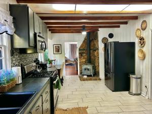 a kitchen with a refrigerator and a stove at EPIC VIEWS, Large Deck, BBQ, Private, Close to Julian, Great for Families or Entertaining in Julian