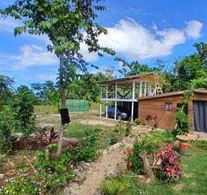 a garden with a house in the background at Island Breeze in Negril