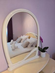 a bedroom with a bed with a large mirror at Nano Apartmani in Smokvica