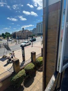 a man sitting on a skateboard next to a building at Beautiful Double room in Peterborough
