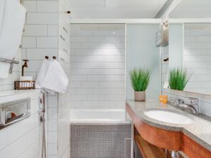 a bathroom with a tub and a sink at Original Sokos Hotel Vaakuna Vaasa in Vaasa