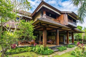 a house with a wrap around porch at Ananda Ubud Resort in Ubud