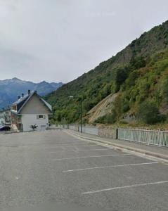 a parking lot with a building and a mountain at Studio Barèges in Barèges +4 photos