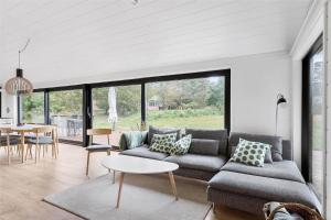 a living room with a couch and a table at 10036-Rorvig-Magevej-11 in Rørvig