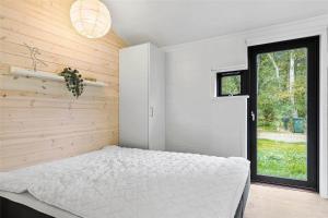 a bedroom with a white bed and a window at 10036-Rorvig-Magevej-11 in Rørvig