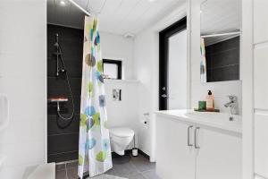 a bathroom with a shower and a toilet and a sink at 10036-Rorvig-Magevej-11 in Rørvig +22 photos