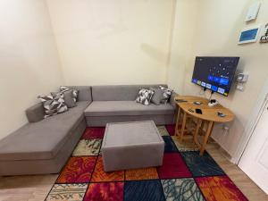 a living room with a couch and a table at Oraby house in Al Ḩammām