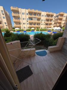 a view of a pool from the balcony of a apartment building at Oraby house in Al Ḩammām