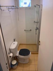 a bathroom with a toilet and a glass shower at Mendoza Centro Apartment in Mendoza +9 photos
