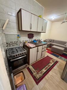 an overhead view of a kitchen with a stove at Oraby house in Al Ḩammām