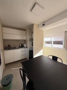 a kitchen with a black table and chairs in a room at Mendoza Centro Apartment in Mendoza