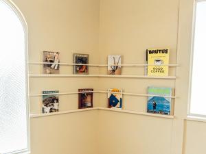 a room with shelves filled with books at By The Tree Room in Amami