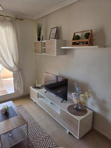 a living room with a entertainment center with a tv at Mar de Cristal in Mar de Cristal