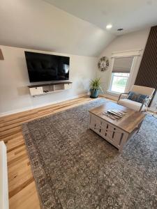 a living room with a couch and a tv at Gorgeous Home in Prime Location in Sauk City