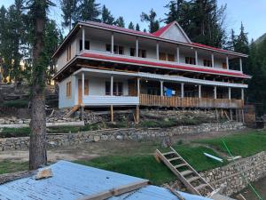 a house being built on top of a hill at Fairy Meadows Comfort Lodges in Tato